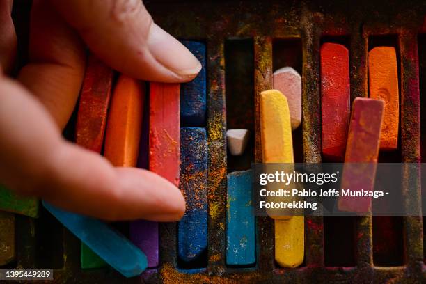 woman takes pastel pencils - pastel colored stock-fotos und bilder