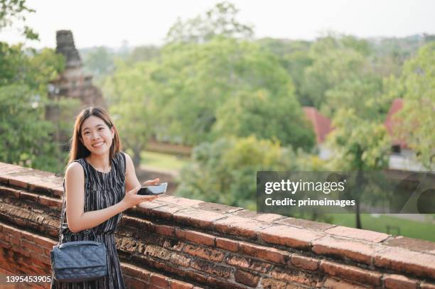 generation z woman traveller having staycation adventure looking temple in ayutthaya province, thailand. - asian generation z stock pictures, royalty-free photos & images