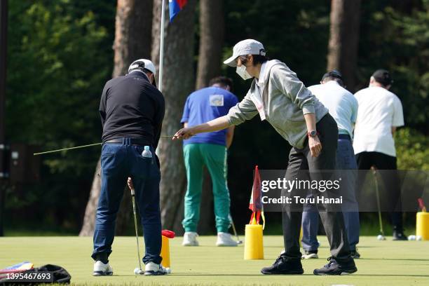 Teaching professional instructs amateur golfers at a practice session during the first round of World Ladies Championship Salonpas Cup at Ibaraki...