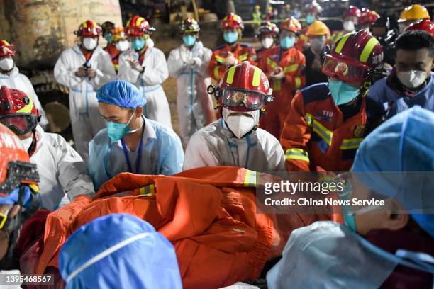 Rescuers carry the 10th survivor at the collapse site of a self-constructed residential building on May 4, 2022 in Changsha, Hunan Province of China....