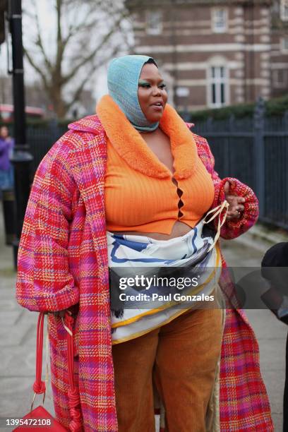 Guest is seen wearing a pink plaid coat at Roksanda during London Fashion Week February 2022 on February 21, 2022 in London, England.