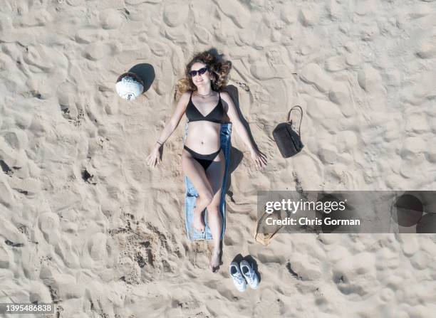 Student Alice poses while sunbathing on Bournemouth Beach on April 15, 2022 in Bournemouth, England.