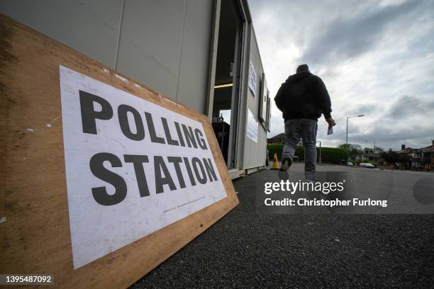 Voters leave after castin their ballot in a temporary polling station as voting opens across the country in the local elections on May 05, 2022 in...