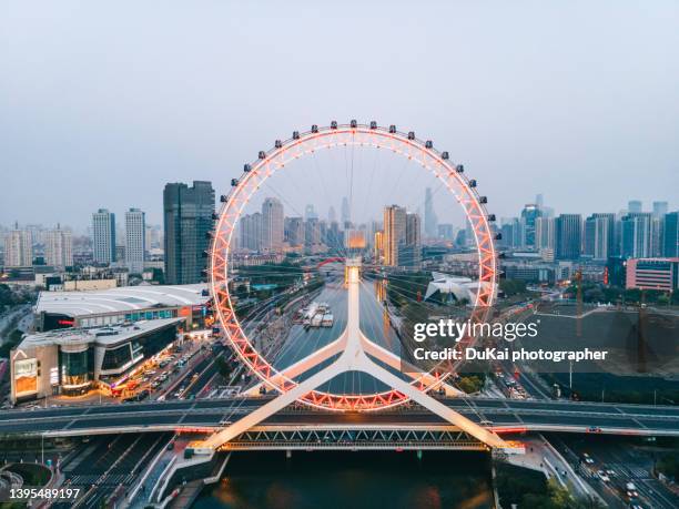 tianjin eye and tianjin urban skyline at night - circular business district stock pictures, royalty-free photos & images