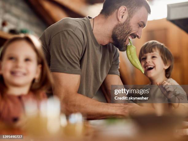 single father having fun with his kids in dining room. - female eating chili bildbanksfoton och bilder