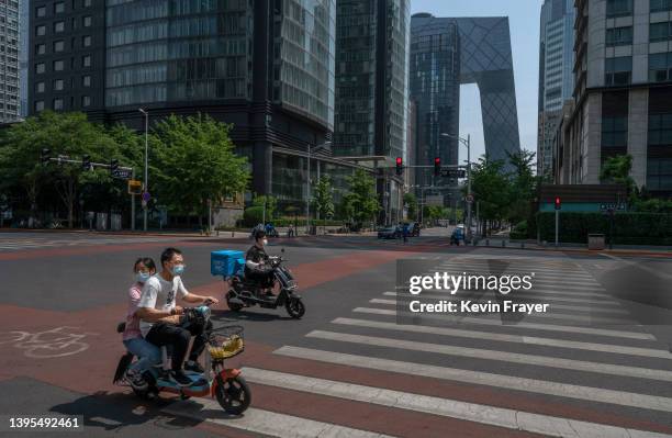 People drive on a quiet street in the Central Business District, after the government recommended people work from home to prevent the spread of...