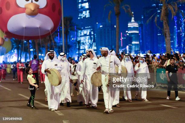 Performers parade through a street during a balloon festival on May 4, 2022 in Doha, Qatar. The balloon festival, hosted by Qatar Tourism, is in...