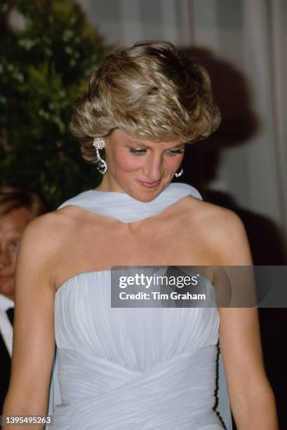 British Royal Diana, Princess of Wales , wearing a pale blue silk chiffon strapless Catherine Walker dress with a matching chiffon stole, attends a...