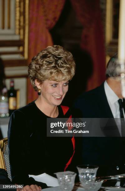 British Royal Diana, Princess of Wales , wearing a midnight blue velvet dress with red detail, attends a dinner, held at the Palace d'Orsay in Paris,...