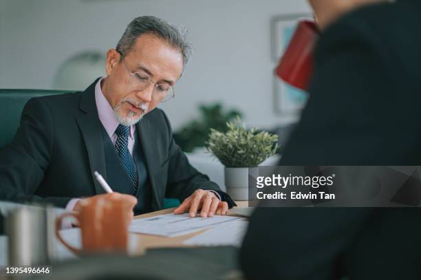 asian ceo businessmen signing document agreement in office - banking paper stock pictures, royalty-free photos & images
