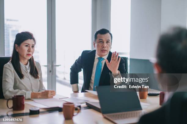 asian head of department argument disagreement in meeting room - bossy stock pictures, royalty-free photos & images