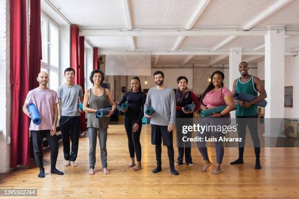 portrait of multi-ethic group of people after yoga session in gym - germany public training session stockfoto's en -beelden