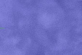 Very peri matte background of suede fabric, macro. Velvet texture of seamless navy blue leather.
