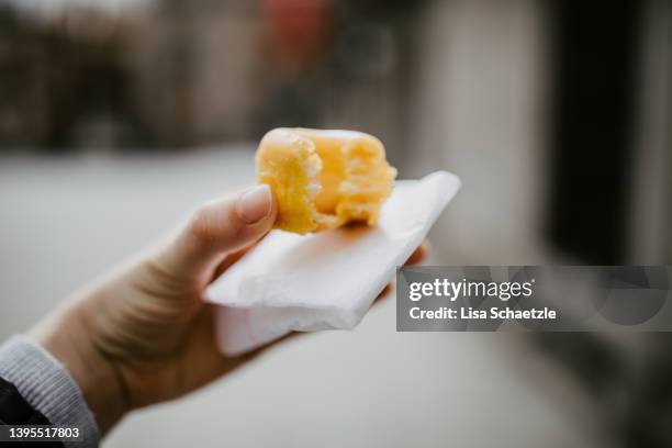 woman holding a small donut in her hand, yolk donuts (rosquillas de alcalá) - rosquillas photos et images de collection