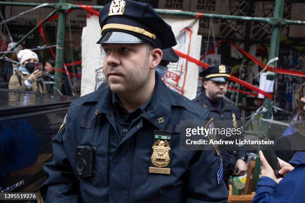 Police enforce a sweep of a homeless encampment, throwing tents and other possessions of the homeless in a trash truck, May 4, 2022 in the East...