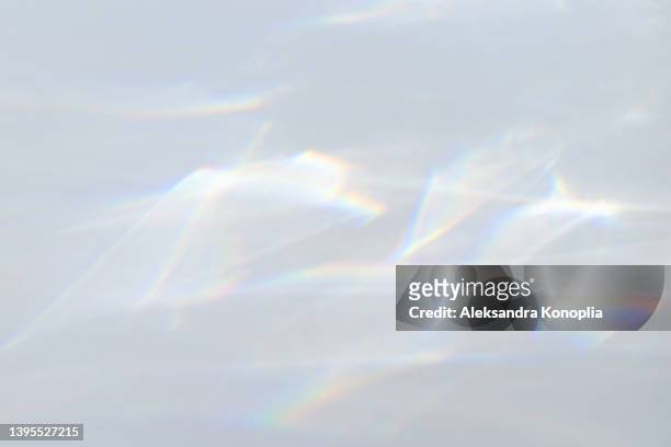 blurred dreamy surreal rainbow light refraction texture overlay effect on white wall - lenses bildbanksfoton och bilder