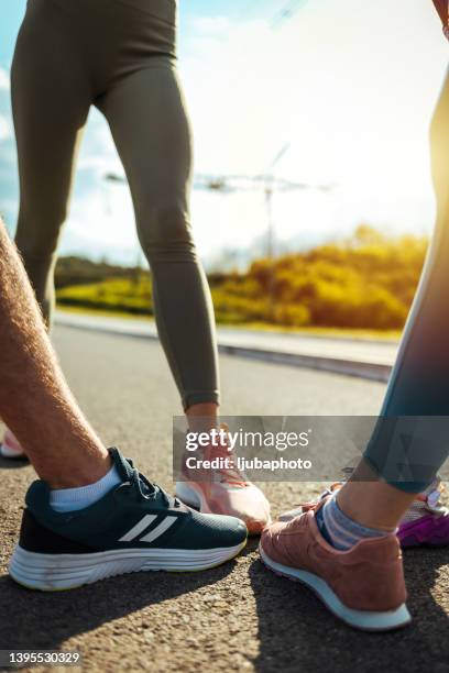 side view of runners standing together. - sports footwear stock pictures, royalty-free photos & images