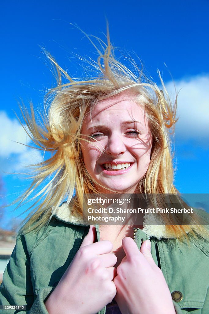 Teenage girl standing in wind storm portrait