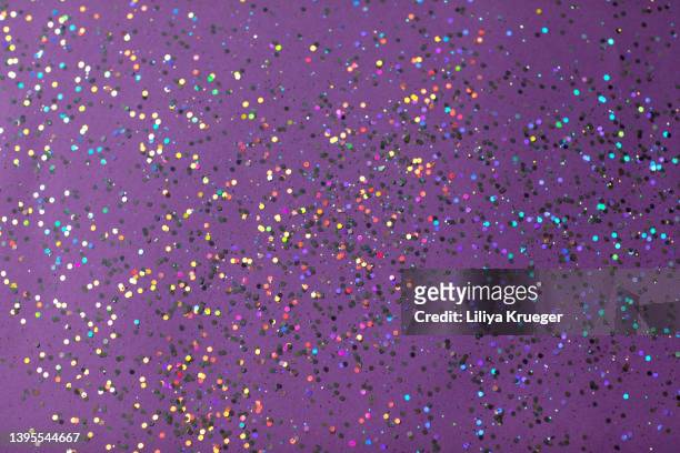 purple festive background with colorful glitter. - purple glitter stock pictures, royalty-free photos & images