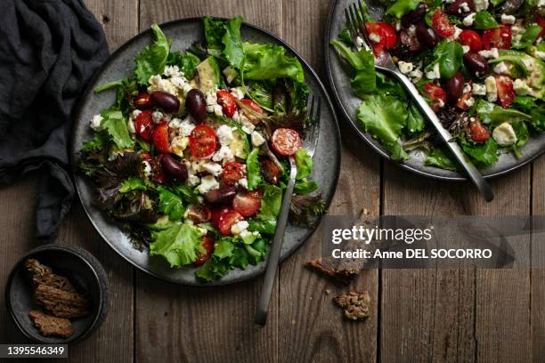 salad with lettuce greek olives feta and tomatoes - mediterranean food ストックフォトと画像