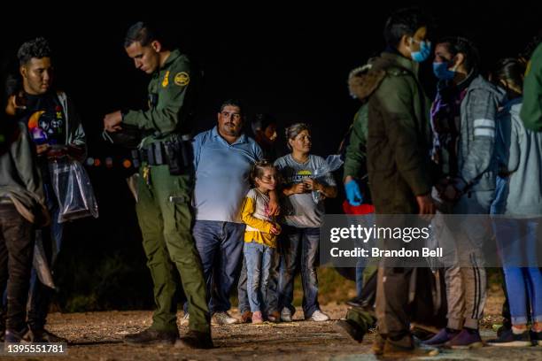 Migrant family stands waiting to be processed on May 05, 2022 in Roma, Texas. Texas Gov. Greg Abbott's "Operation Lone Star" directed approximately...