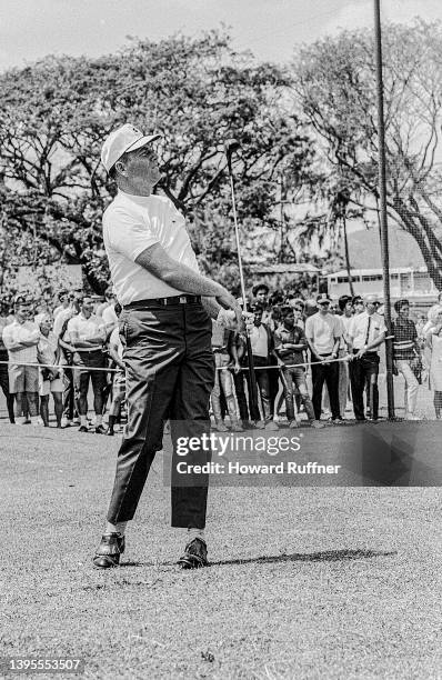 American professional golfer Billy Casper plays golf for an audience of uniformed soldiers and others at Clark Air Base, Luzon, Philippines, February...