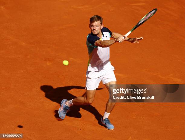 David Goffin of Belgium plays a backhand in their round of 16 match against Rafael Nadal of Spain during day eight of Mutua Madrid Open at La Caja...