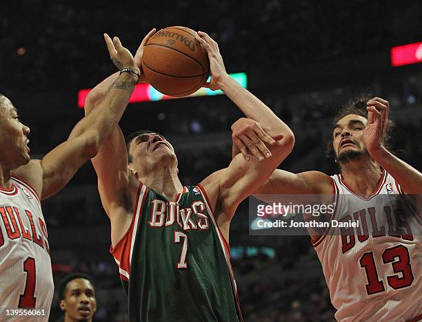 Ersan Ilyasova of the Milwaukee Bucks tries to shoot between Derrick Rose and Joakim Noah of the Chicago Bulls at the United Center on February 22,...