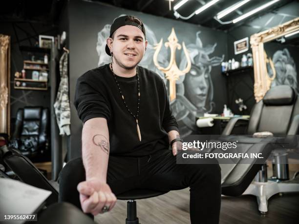young latin man at the tattoo parlour - showing off stock pictures, royalty-free photos & images