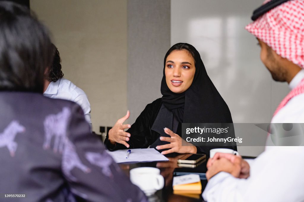 Young Saudi professional describing ideas for new business