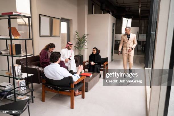 saudi coworkers taking a break for tea and conversation - coworking stock pictures, royalty-free photos & images
