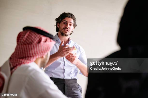 candid view of middle eastern businessman making sales pitch - er riad stock pictures, royalty-free photos & images