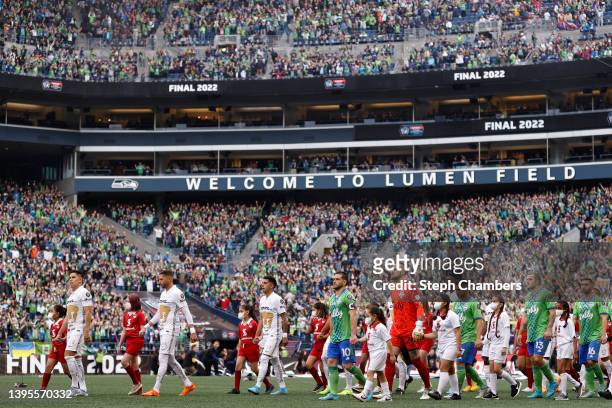Players of the Seattle Sounders and Pumas make their way to center field during 2022 Scotiabank Concacaf Champions League Final Leg 2 at Lumen Field...