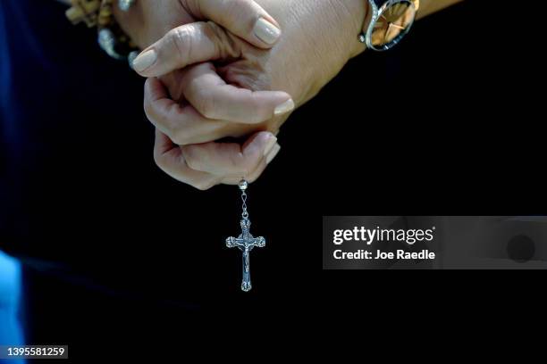 Juliana Vijil holds a rosary chain as she participates in a National Day of Prayer service at the St. Augustine Church on May 05, 2022 in Coral...