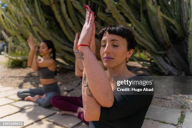 women practicing yoga. - frau schön kaktus stock-fotos und bilder