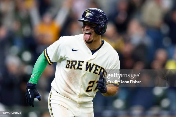 Willy Adames of the Milwaukee Brewers reacts toward the Brewers bench after hitting a home run in the ninth inning against the Cincinnati Reds at...