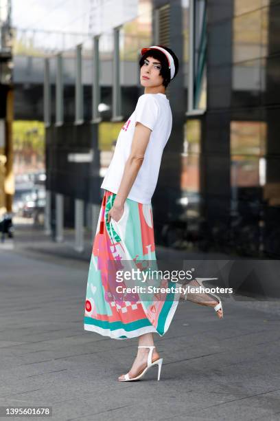 Model and artist Zoe Helali wearing a white t-shirt with pink front print by Miss Goodlife, a multicolored maxi skirt by Miss Goodlife, vintage white...