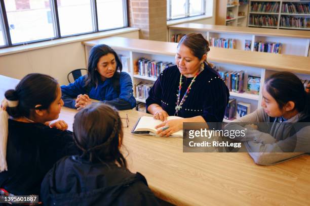 high school teacher and students in a school library - high school student stock pictures, royalty-free photos & images