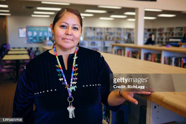 high school teacher in a library - minority groups professional stock pictures, royalty-free photos & images