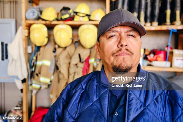 firefighter in a fire station - firefighter uniform stock pictures, royalty-free photos & images