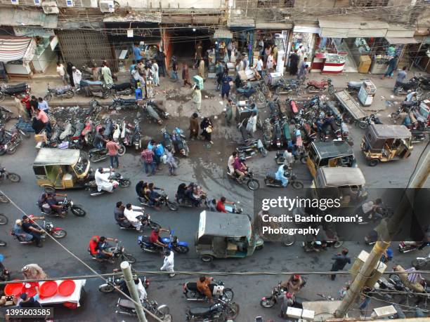 people and traffic passing by a road - karachi stock pictures, royalty-free photos & images