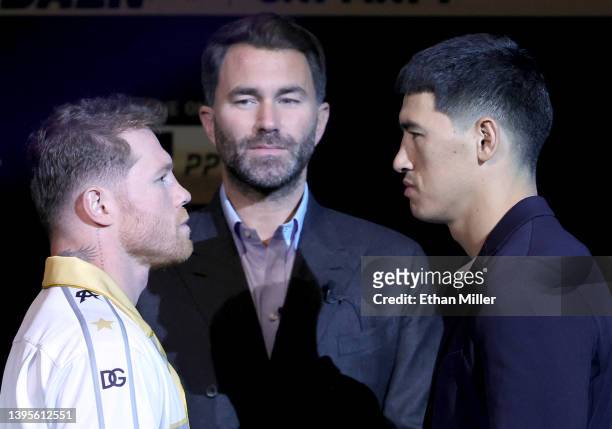 Matchroom Sport Chairman Eddie Hearn looks on as Canelo Alvarez and WBA light heavyweight champion Dmitry Bivol face off during a news conference at...