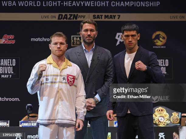 Matchroom Sport Chairman Eddie Hearn looks on as Canelo Alvarez and WBA light heavyweight champion Dmitry Bivol pose during a news conference at the...
