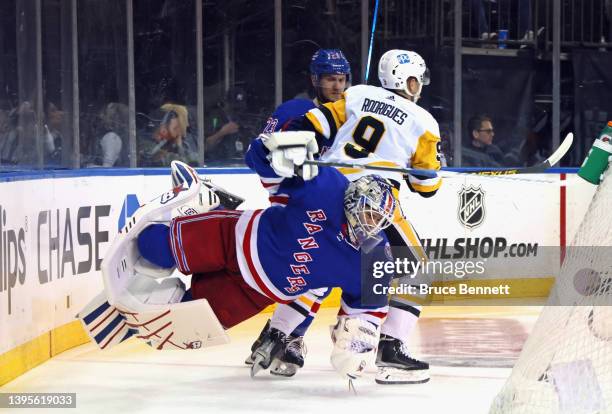 Evan Rodrigues of the Pittsburgh Penguins bumps into Igor Shesterkin of the New York Rangers during the first period in Game Two of the First Round...