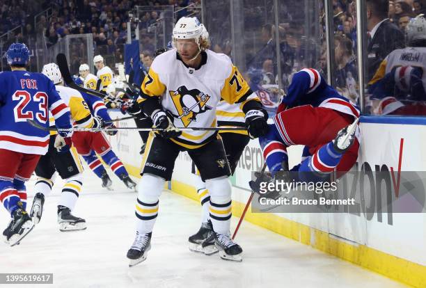 Ryan Strome of the New York Rangers is checked by Jeff Carter of the Pittsburgh Penguins during the first period in Game Two of the First Round of...
