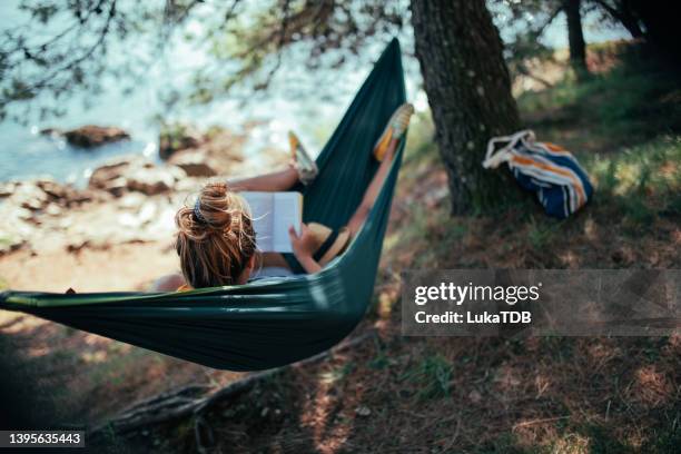 getting replenished - woman reading book stock pictures, royalty-free photos & images