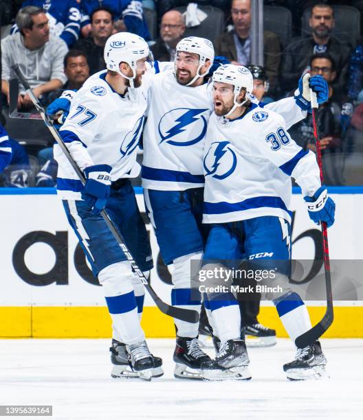 Brandon Hagel of the Tampa Bay Lightning celebrates his goal with Nicholas Paul, and Victor Hedman against the Toronto Maple Leafs during the third...