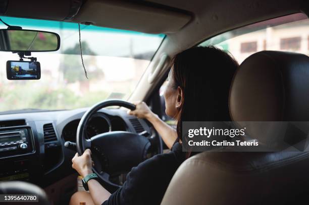 woman driving with a dashboard camera - dashboard camera point of view stock pictures, royalty-free photos & images