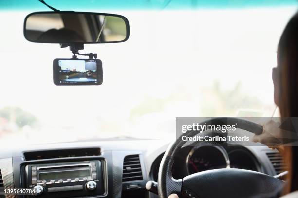 woman driving with a dashboard camera - dashboard camera point of view stock pictures, royalty-free photos & images