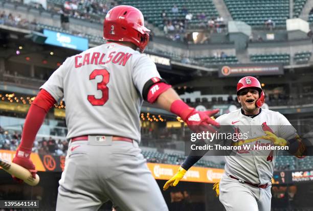 Yadier Molina and Dylan Carlson of the St. Louis Cardinals celebrates after Molina hit a solo home run against the San Francisco Giants in the top of...